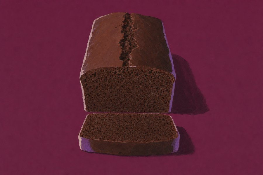 A plain rectangular chocolate loaf cake split along the top crust, two thick slices cut and lying flat in front of it showing a close even dark crumb.