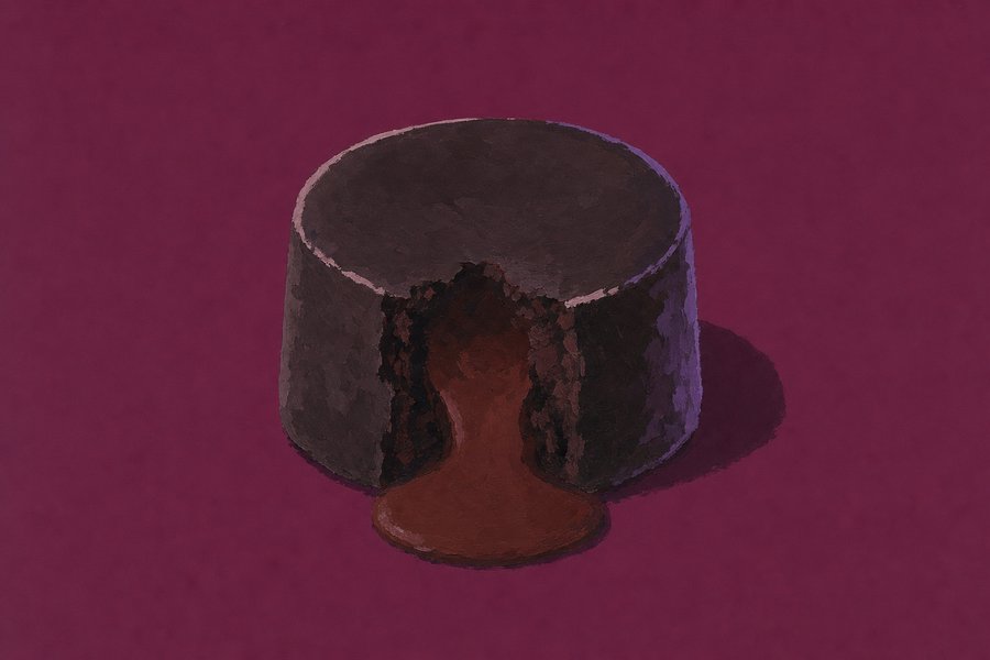 A small straight-sided chocolate fondant broken open at the front, a thick dark centre running out of it.